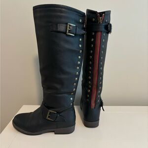 JG pull on knee high black flat boot with buckle, rivets, red accents